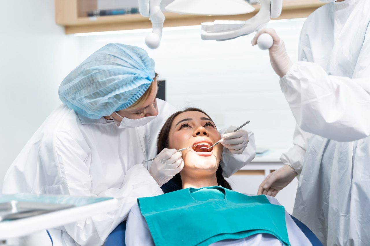 caucasian-dentist-examine-tooth-for-young-girl-at-dental-health-clinic-.jpg