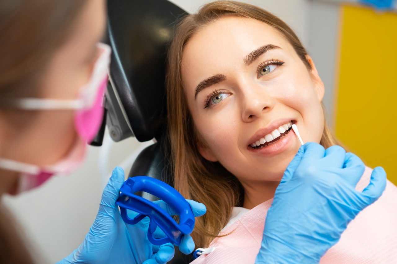 dentist-applies-plaque-detector-on-front-teeth-in-clinic.jpg