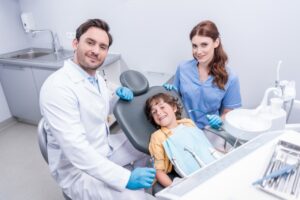 dentists-preparing-little-boy-for-examining-teeth-at-dentist-office.jpg