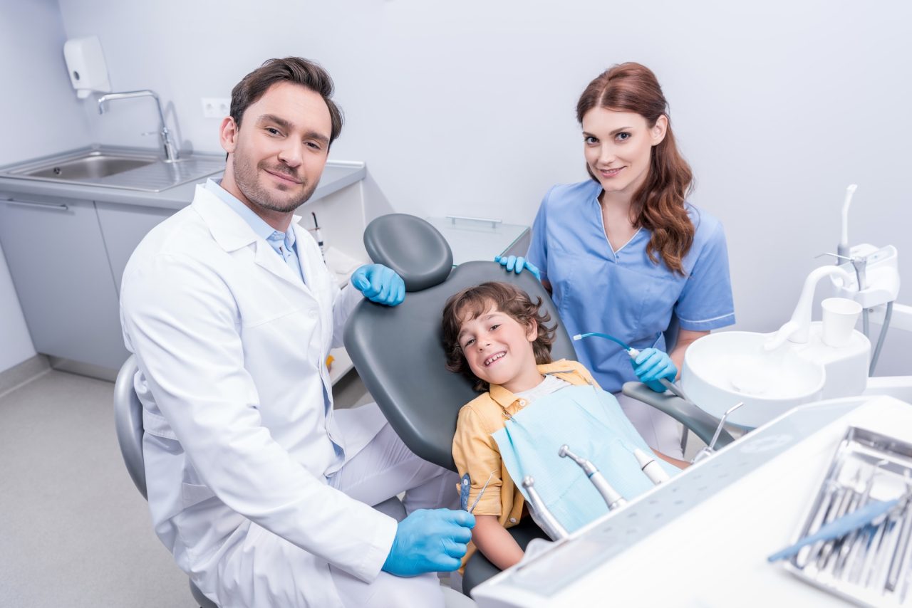 dentists-preparing-little-boy-for-examining-teeth-at-dentist-office.jpg